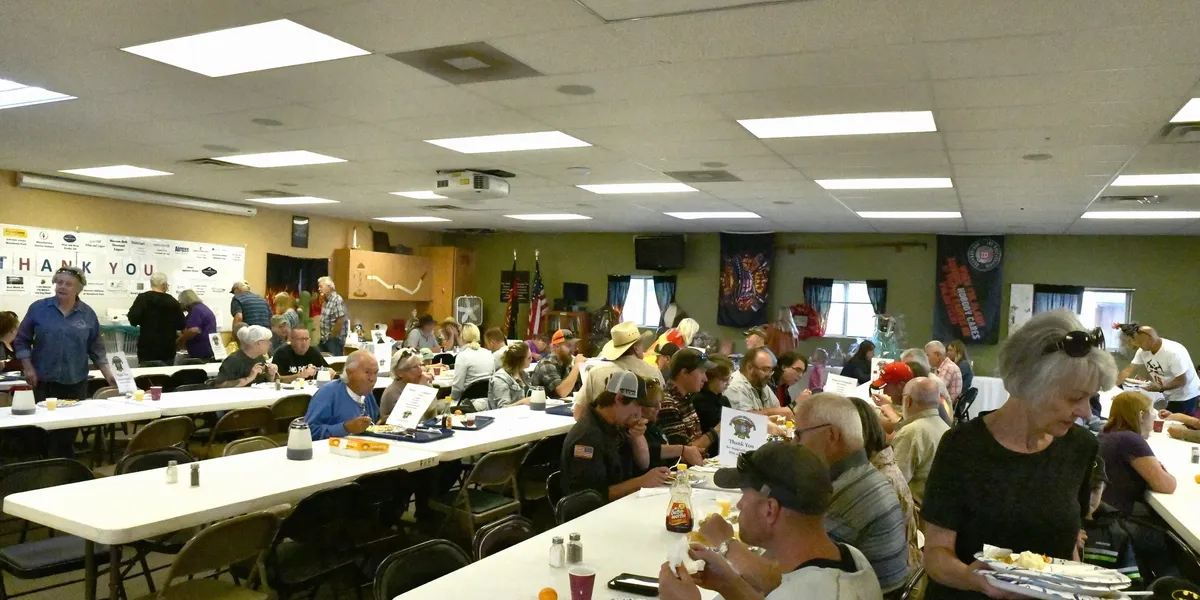 People sitting at rows of tables in the training room